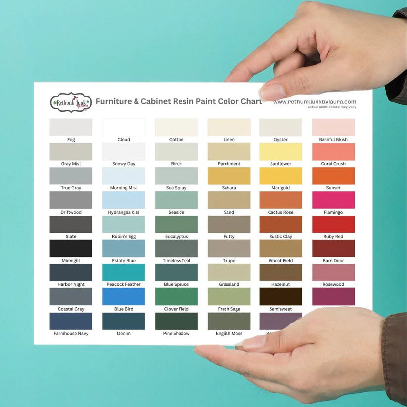 Person holding a color chart for furniture and cabinet resin paint against a teal background