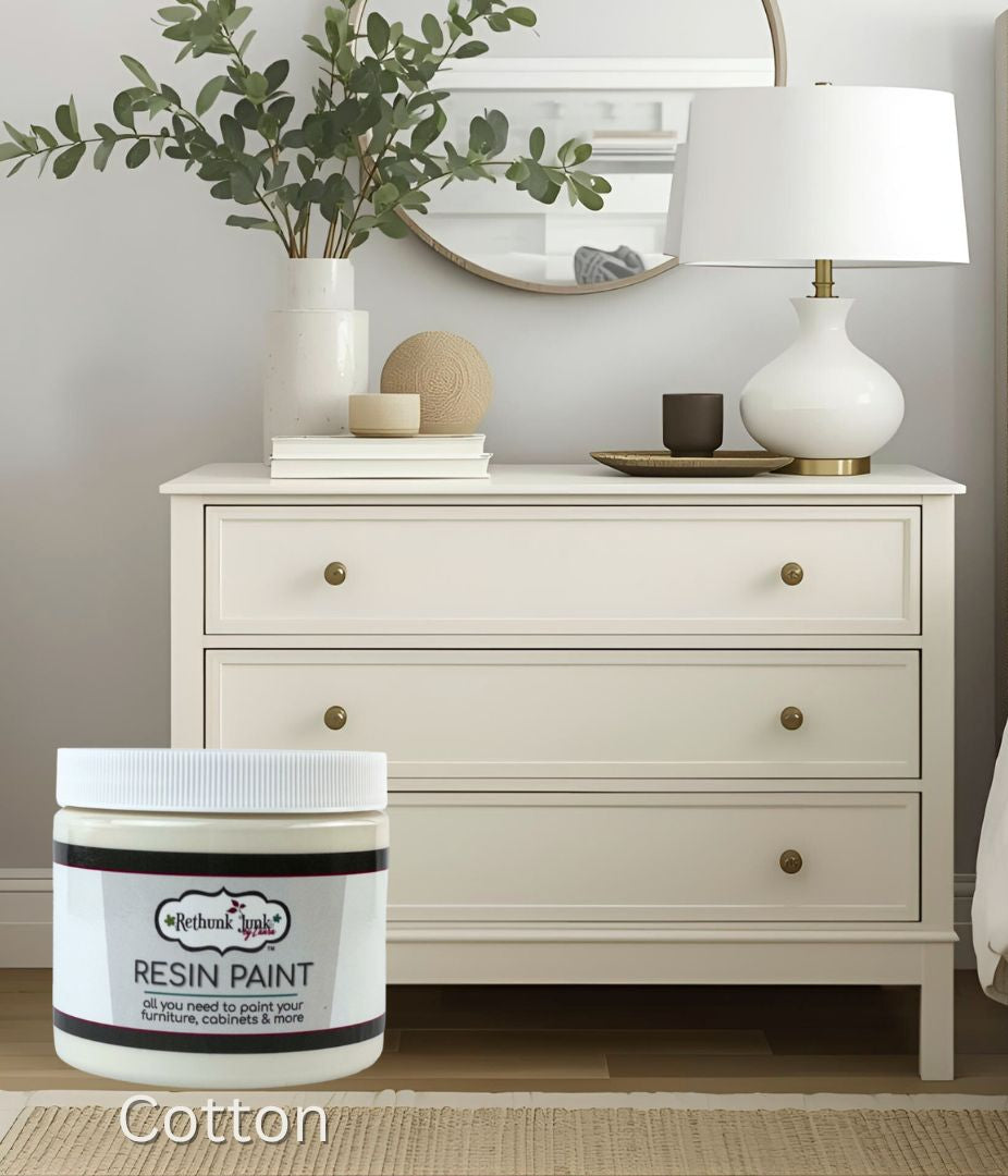 Jar of resin paint labeled 'Cotton' in a bedroom setting with a dresser and lamp.