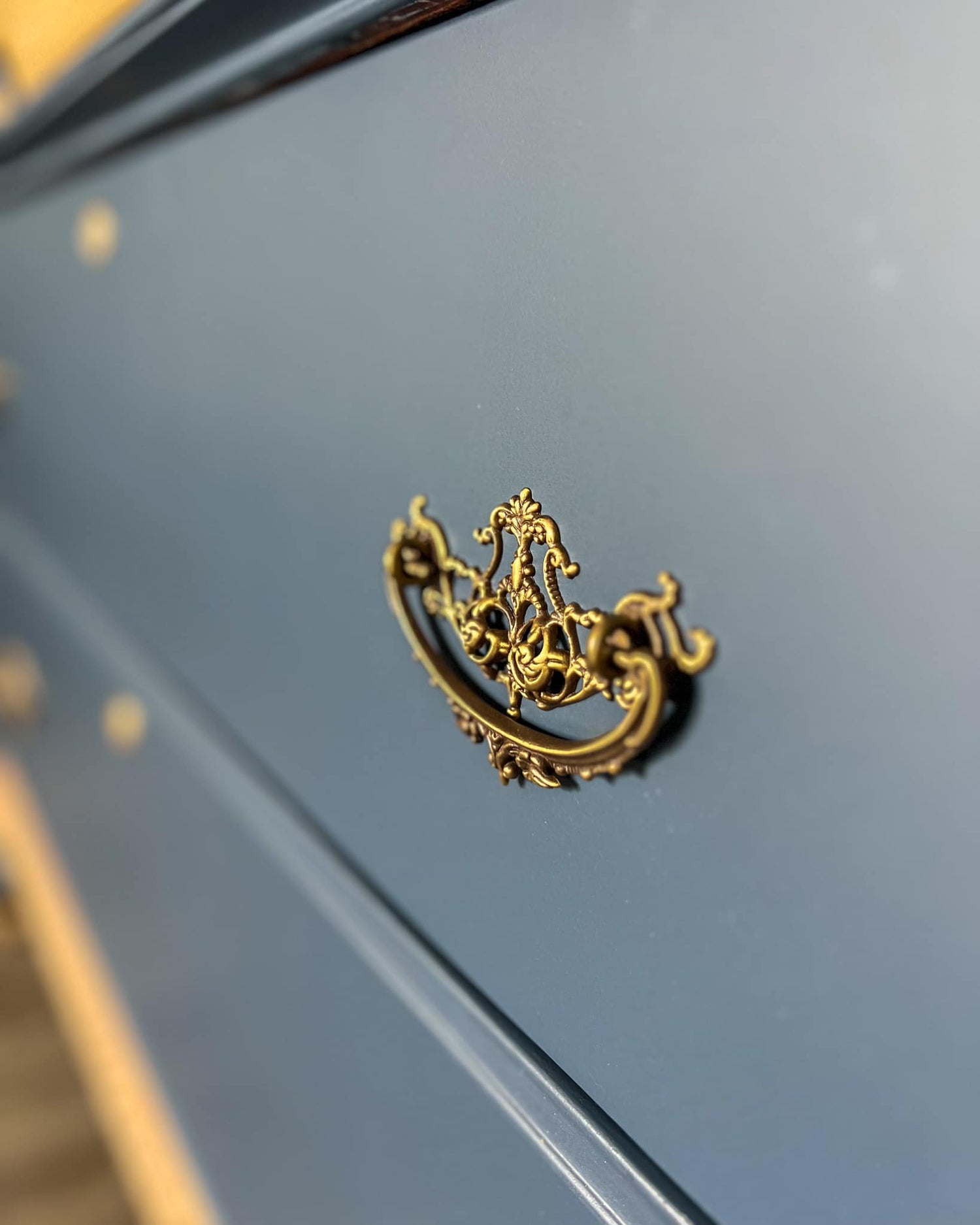 Decorative gold handle on a blue surface