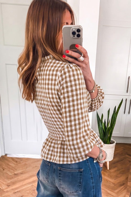 Side view of a taupe and cream gingham smocked peplum top
