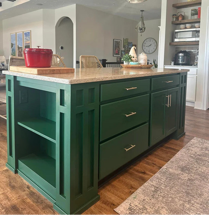 Green kitchen island with wooden countertop in a home setting
