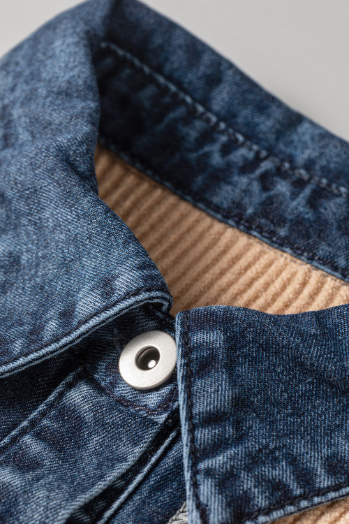 Close-up of the denim-look collar, tan ribbed knit, and button detail on a cardigan